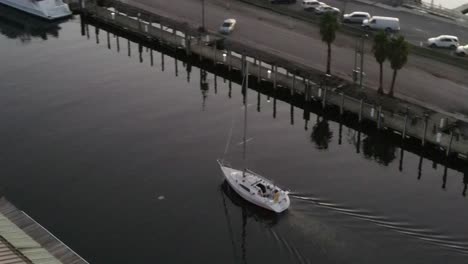 aerial of yacht cruising at west end point near new canal lighthouse during sunset in new orleans, louisiana usa.