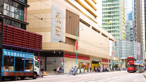 tram moves through bustling hong kong cityscape