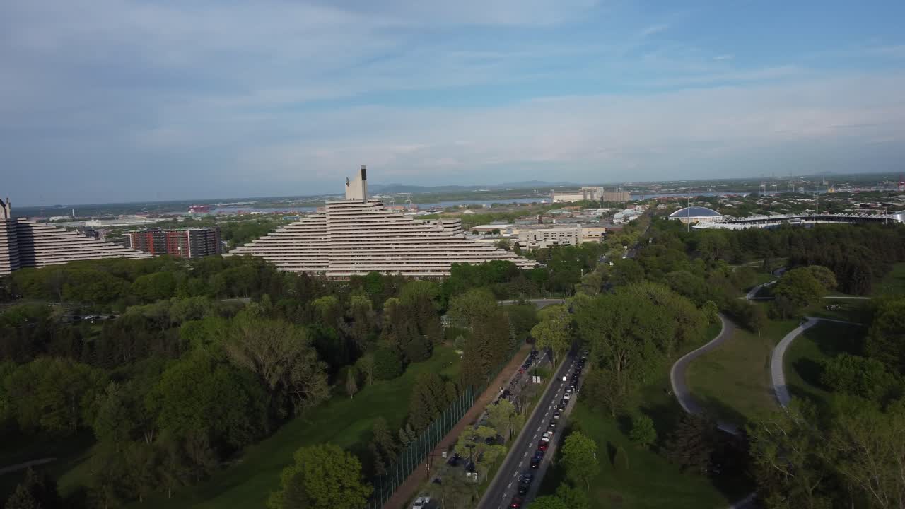 Aerial of apartment building surrounded by green trees