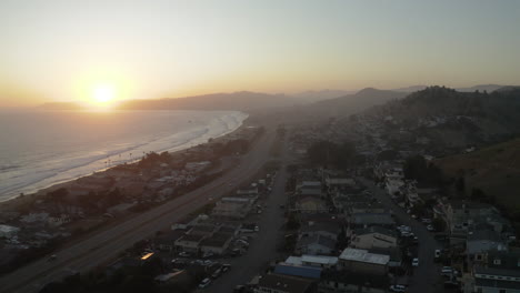 aerial view of a coastal town and highway at sunset