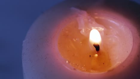 One-candle-in-the-dark-in-the-blue-background