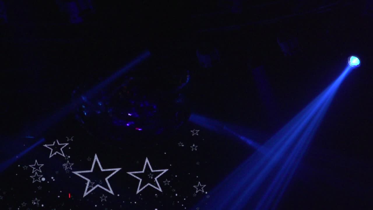 Theater lighting, blue light and stars in background. Pan left