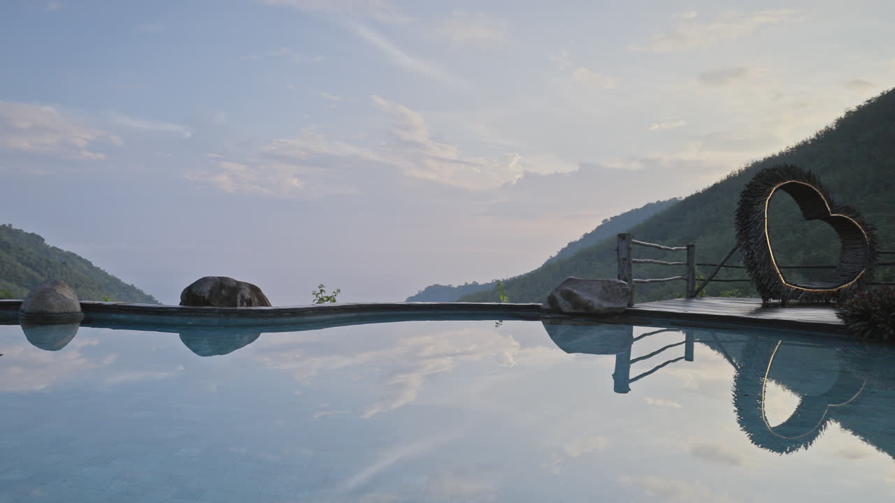 luxury swimming pool set in lush countryside of palm trees