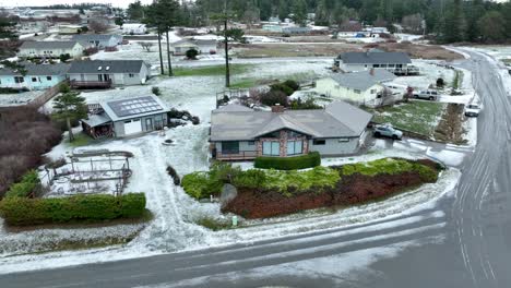 snow covered rural home with solar panels on whidbey island