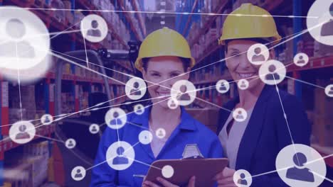 network of profile icons against portrait of female supervisor and worker smiling at warehouse