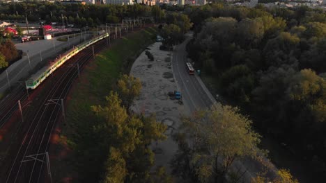 Aerial-photo-of-the-train-entering-the-city-at-sunset