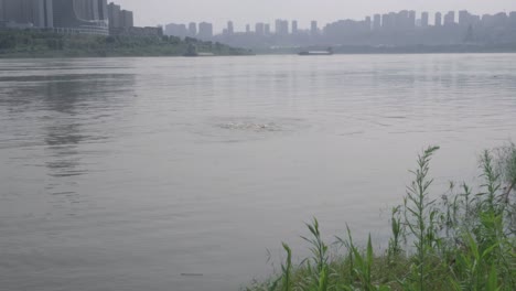 a man swimming in a river and gradually sinking into the water