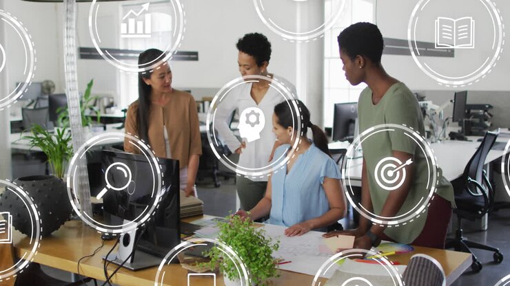 Animation of multiple digital icons against group of diverse women discussing together at office