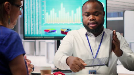 insurance adviser explaining retirement plans to mature people in a modern office