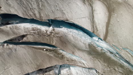 pasterze glacier crevasse in eastern alps, aerial closeup shot