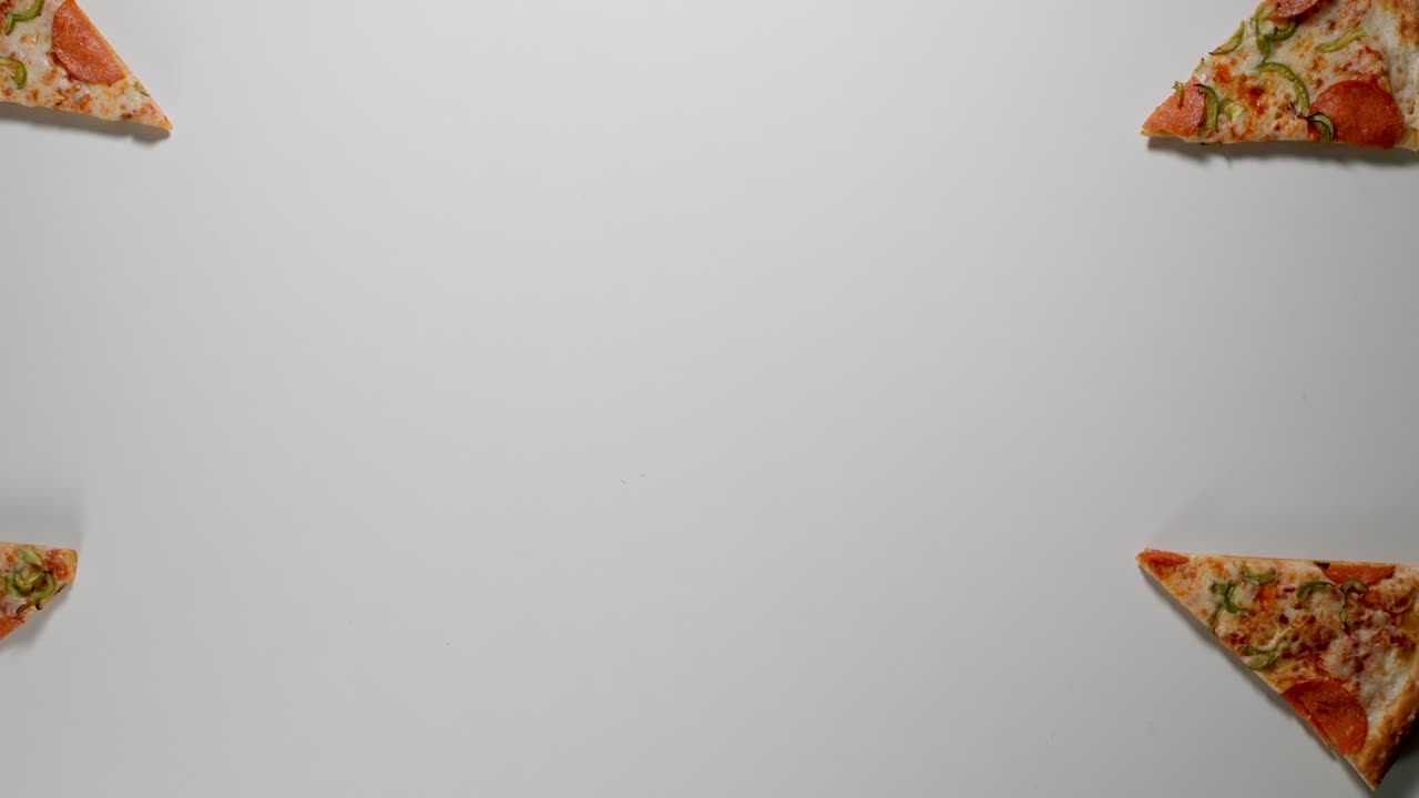 Slices Of Big Pizza Is Eaten Up On A White Table in Different Directions