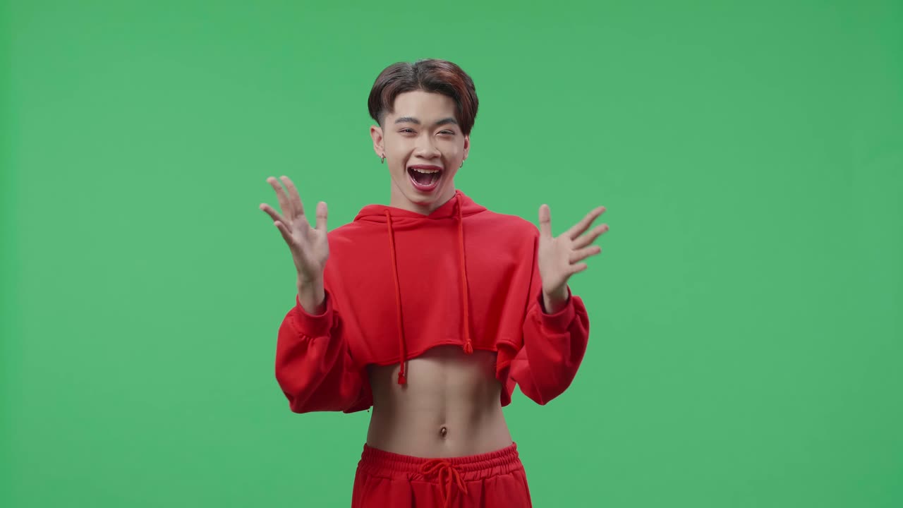 The Shocked Asian Transgender Male Grabbing His Head While Saying Wow On Green Screen Background In The Studio