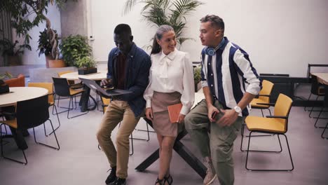 diverse colleagues browsing laptop together