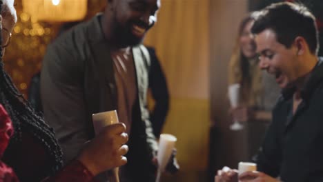 tracking shot of a group of friends dancing in a bar