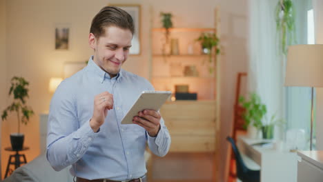 Businessman-Manages-Finances-on-Tablet