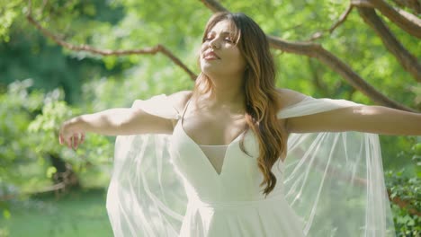 hermosa novia latina en el día de la boda de verano al aire libre con una gran sonrisa y un maquillaje impresionante con un vestido blanco bastante impresionante