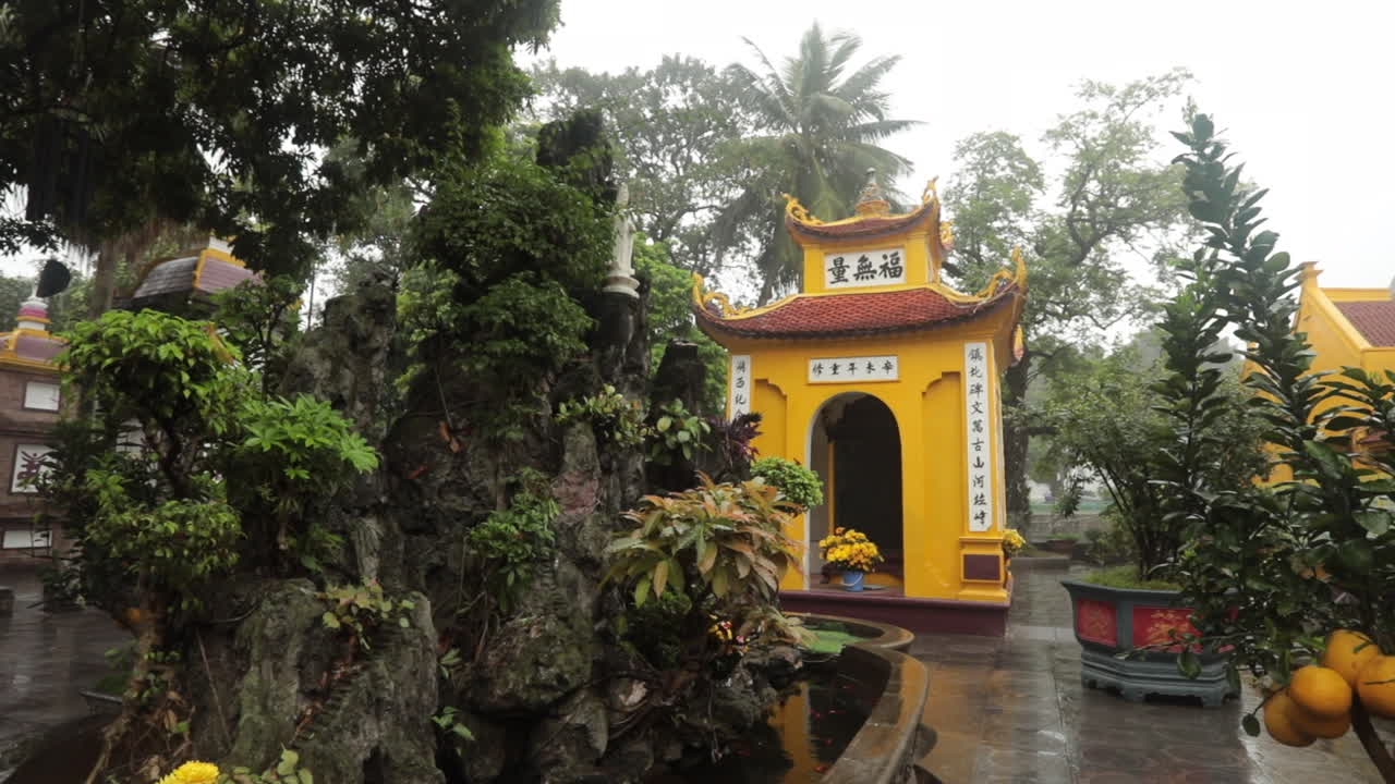 Peaceful temple garden in Hanoi surrounded by greenery and traditional architecture