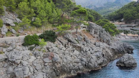 Panoramic-side-shot-of-the-boardwalk-and-town-at-Sa-Calobra,-Mallorca,-Spain-during-spring