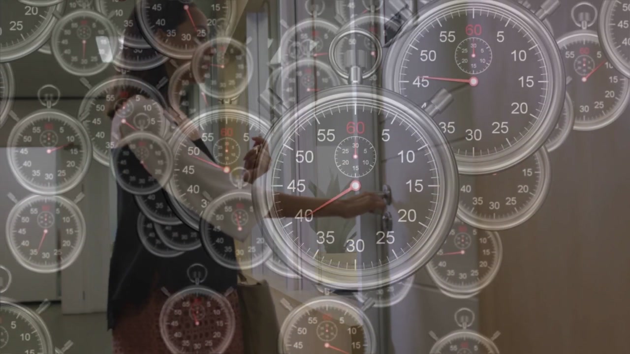 Woman walking office hall, pausing at door, opening door and entering to use desk, timers overlay