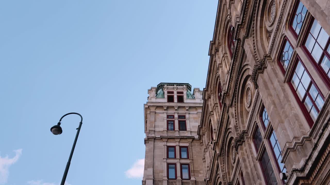 Detailed stone facade of a historic building with arched windows in Vienna, Austria