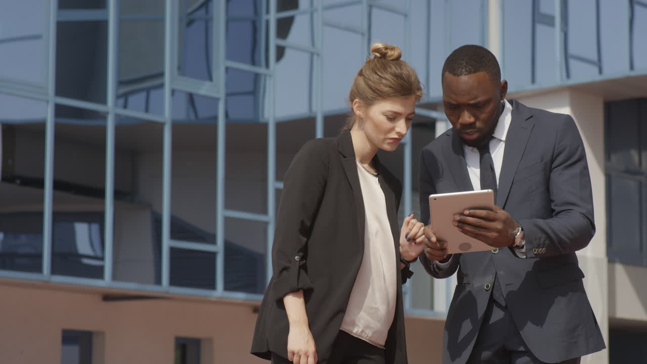 Business Couple Using Digital Tablet Near Office