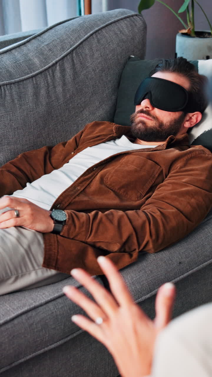 Man Relaxing on a Couch with a Sleep Mask