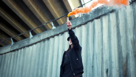 girl protesting on street with smoke bomb in hand. woman holding smoke flare