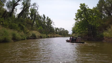 Group-Of-People-Kayaking-In-Peaceful-Quiet-River,-Exploring-Wild-Nature