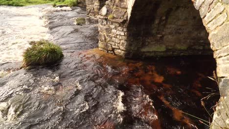 View-of-bridges-of-rough-stone-in-the-middle-of-the-national-park-in-the-English-country-side-with-a-stream-under-it