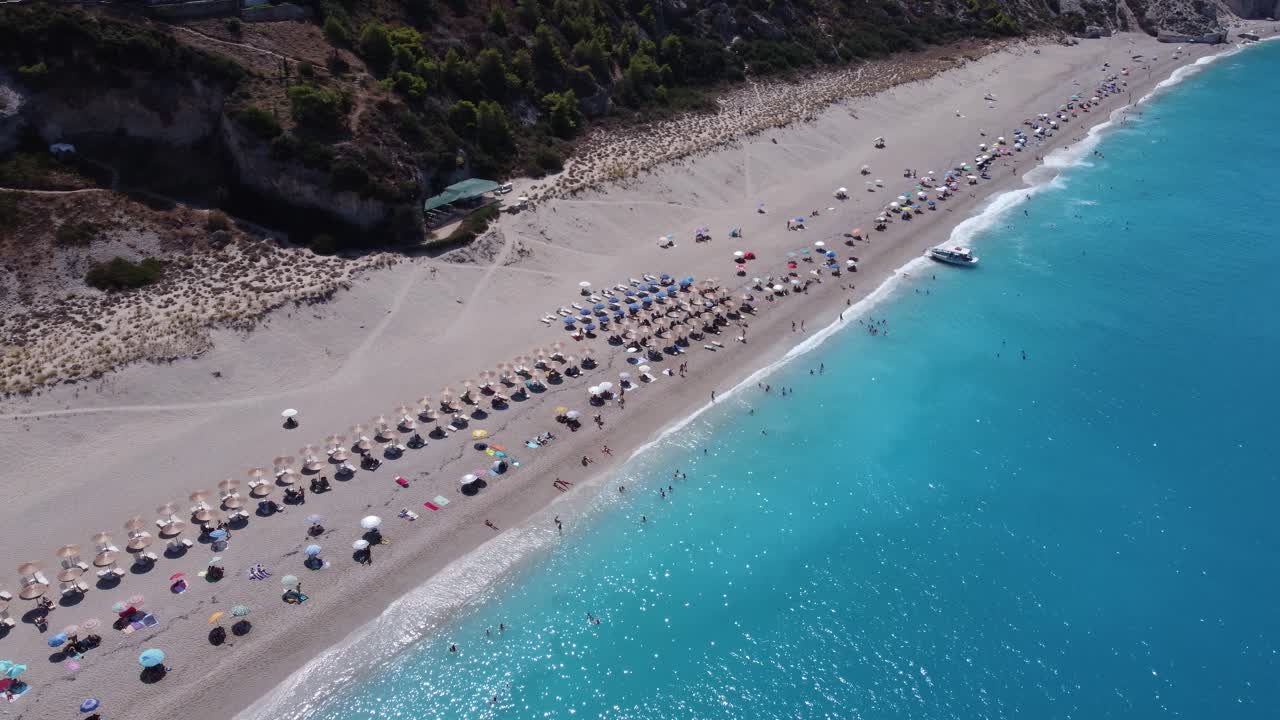 Aerial view of the beautiful Milos beach with fluorescent turquoise sea on the Ionian island of Lefkada, Greece D-Log M