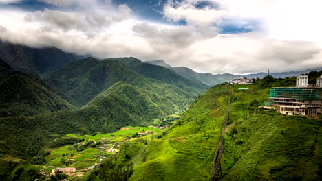Drone hyperlapse of clouds flowing over Fansipan mountain and view of cable car