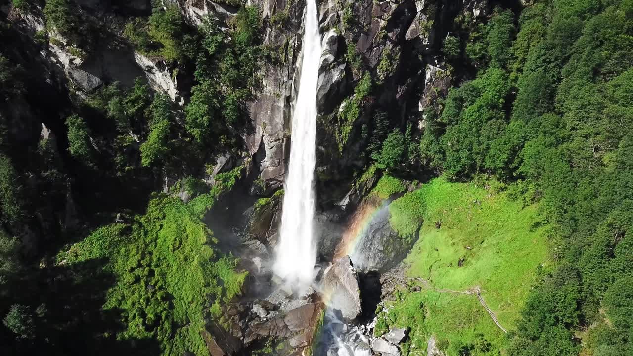 Foroglio waterfall cascading into lush green Bavona Valley, creating picturesque natural rainbow, natural beauty in Ticino, Switzerland, a popular tourist destination with stunning alpine landscapes