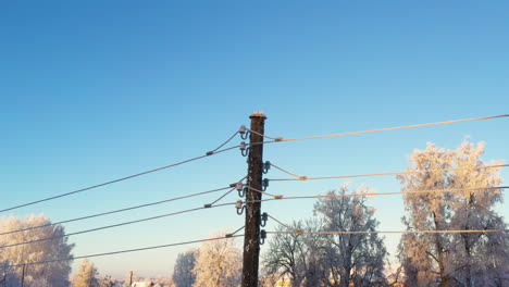 Electrical-wires-covered-in-ice-with-blue-sky-background-and-space-for-text