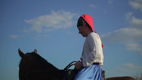 ukrainian cossack riding a horse in the field looks far 04