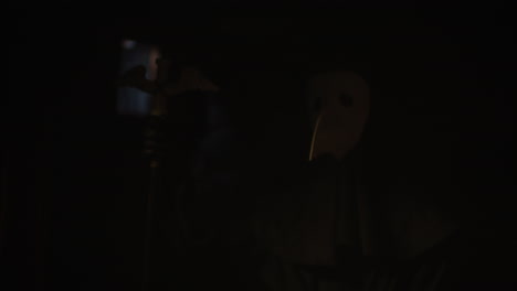 plague doctor in dark room