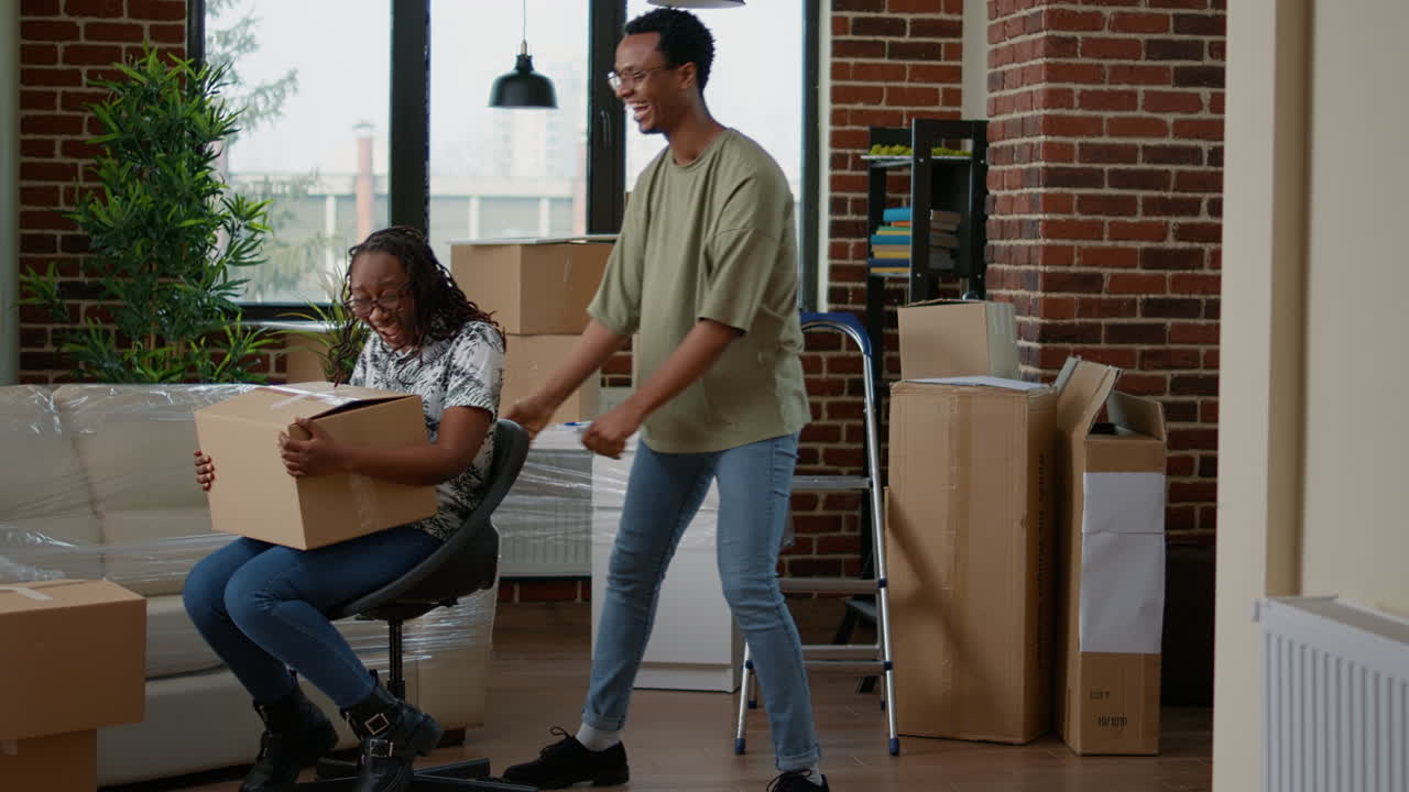 Life partners having fun moving in new household flat