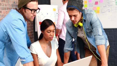 Businesspeople-interacting-while-using-laptop