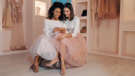 two women shopping online in a stylish dressing room