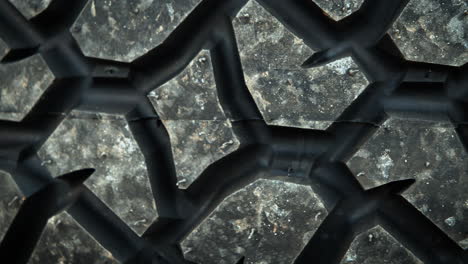 a dolly macro shot of a tire tread pattern, laying down