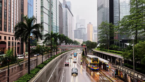 traffic driving on gloucester road in hong kong on a gloomy overcast day