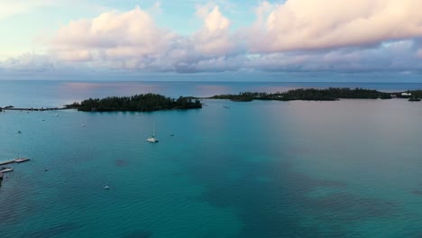 aerial view of big clear turquoise ocean by tropical island
