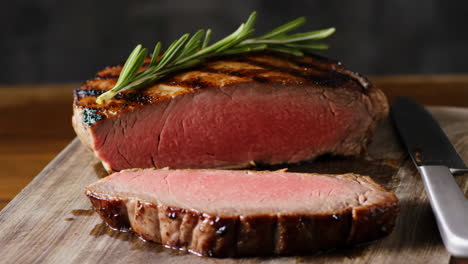 grilled medium-rare steak with rosemary