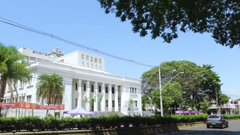 construcción del ayuntamiento municipal de bauru, vista exterior con tráfico local, bonito cielo azul y árboles