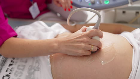 process of ultrasonography. doctor checking baby in pregnant woman's belly. modern technology medical equipment for sonogram.