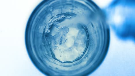 pouring fresh pure sparkling water from bottle into a glass