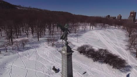 aerial shot over mont-royal statue in montréal.