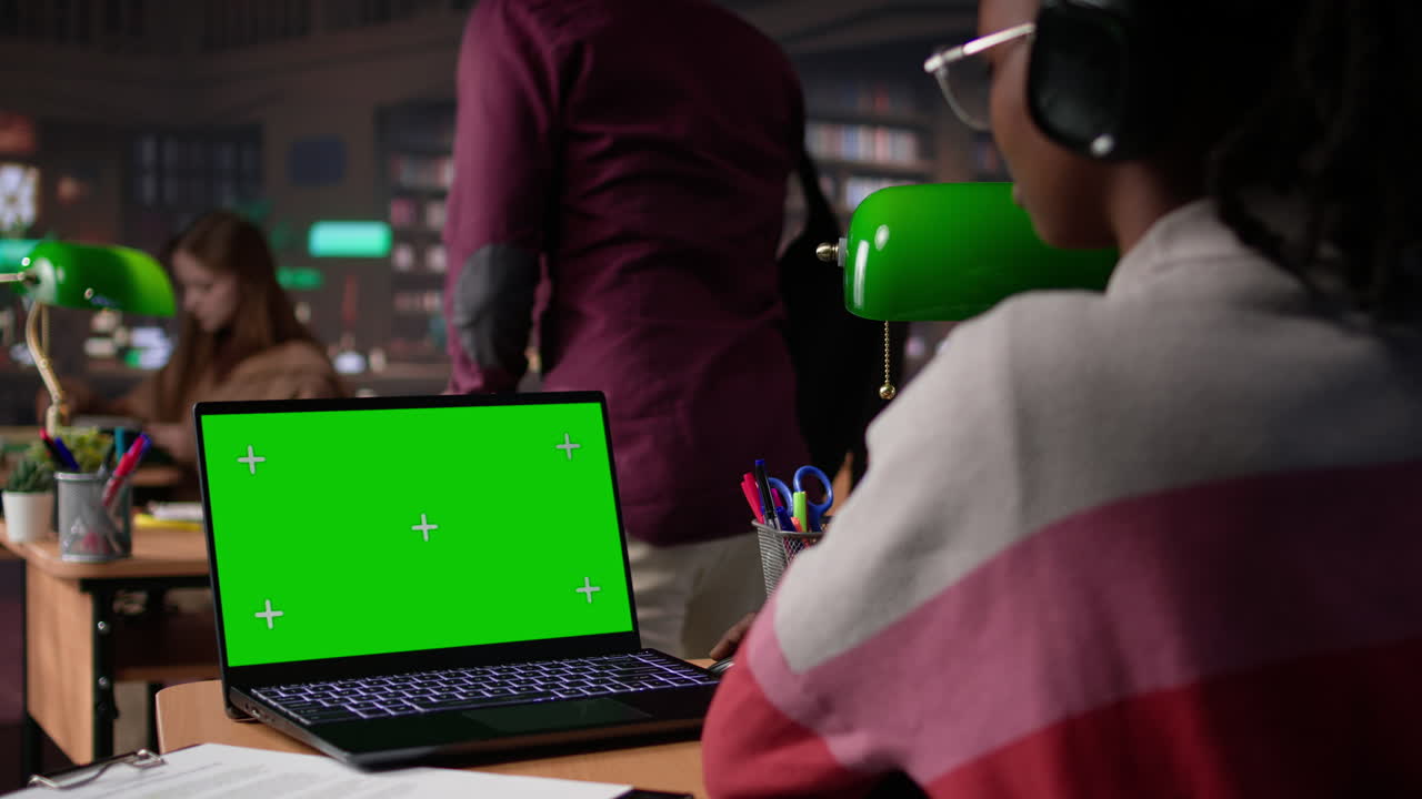 Vertical video african american pupil uses green screen extracting citations from books