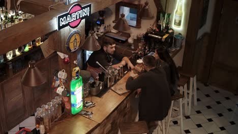 customers enjoying drinks at a rustic bar