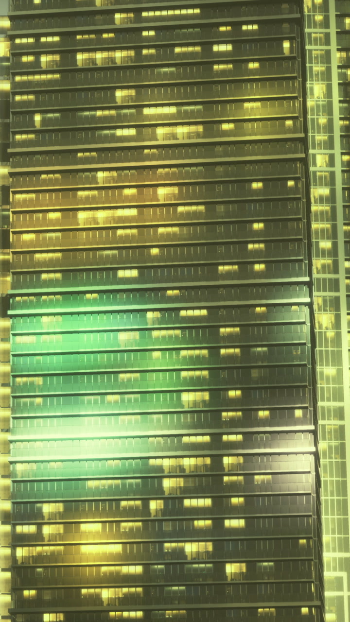 City skyline view at night with buildings lit in yellow and green lights