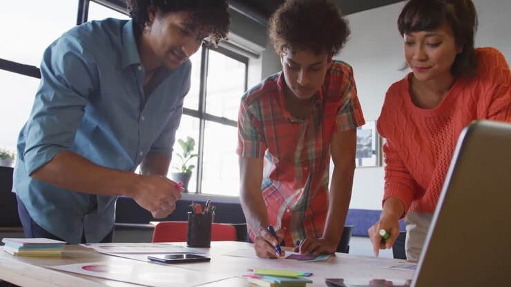 Happy diverse business people discussing work during meeting at office
